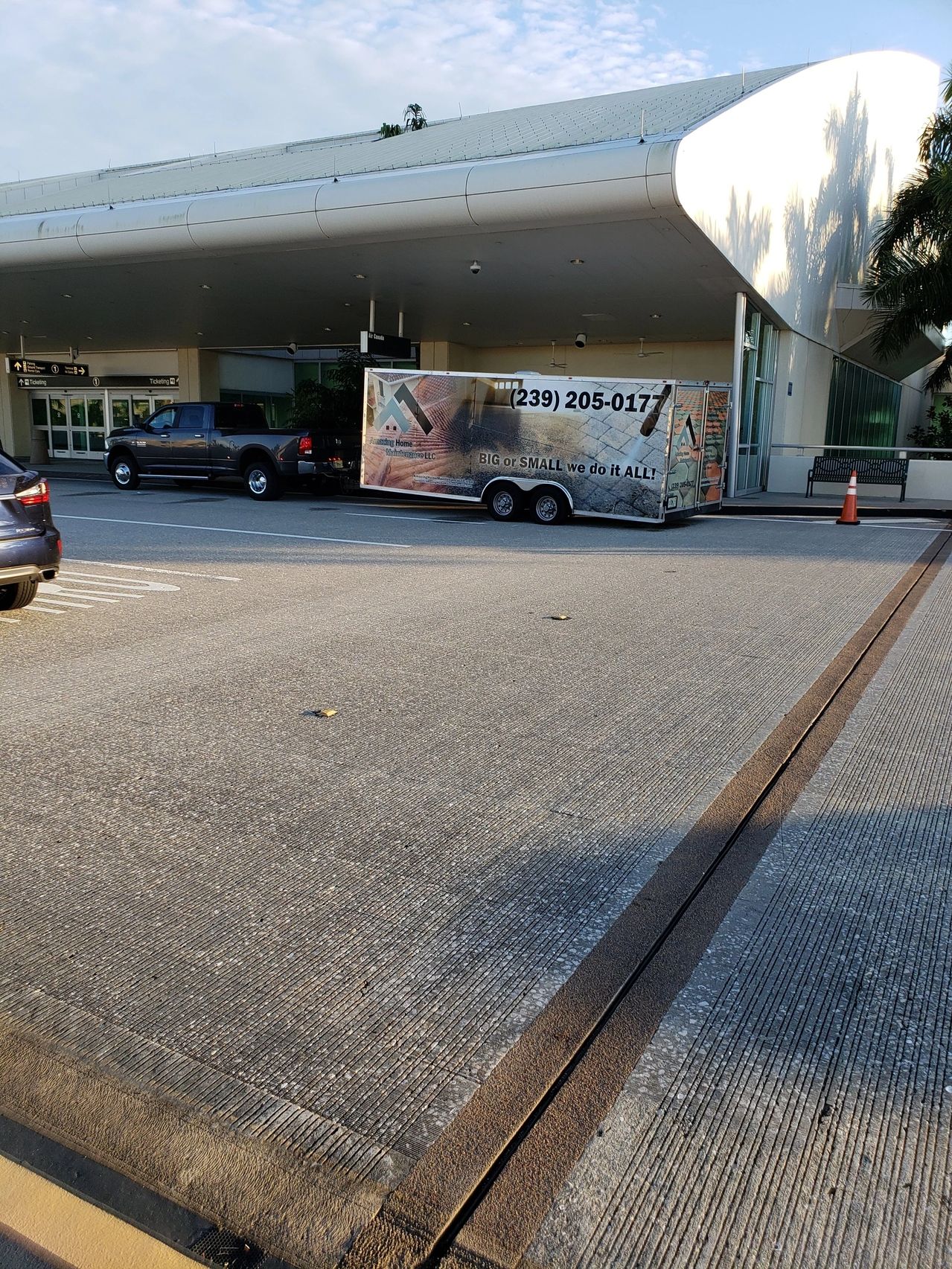 Pickup towing advertising trailer at building entrance