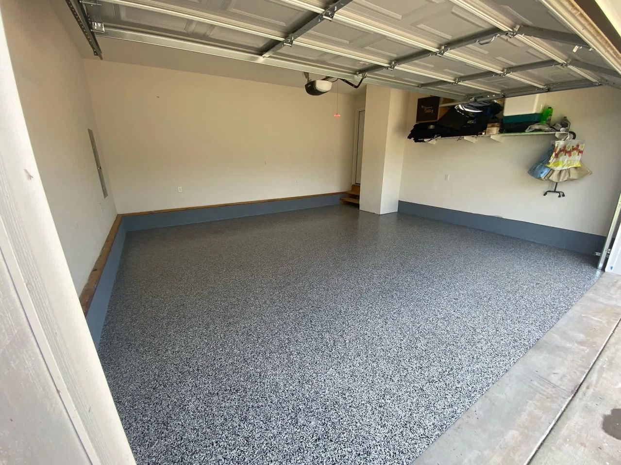 Empty two-car garage with speckled epoxy floor