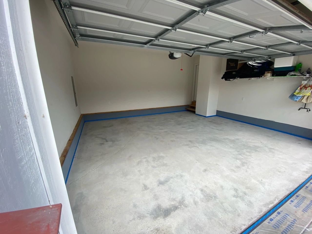 Empty garage with concrete floor and open door