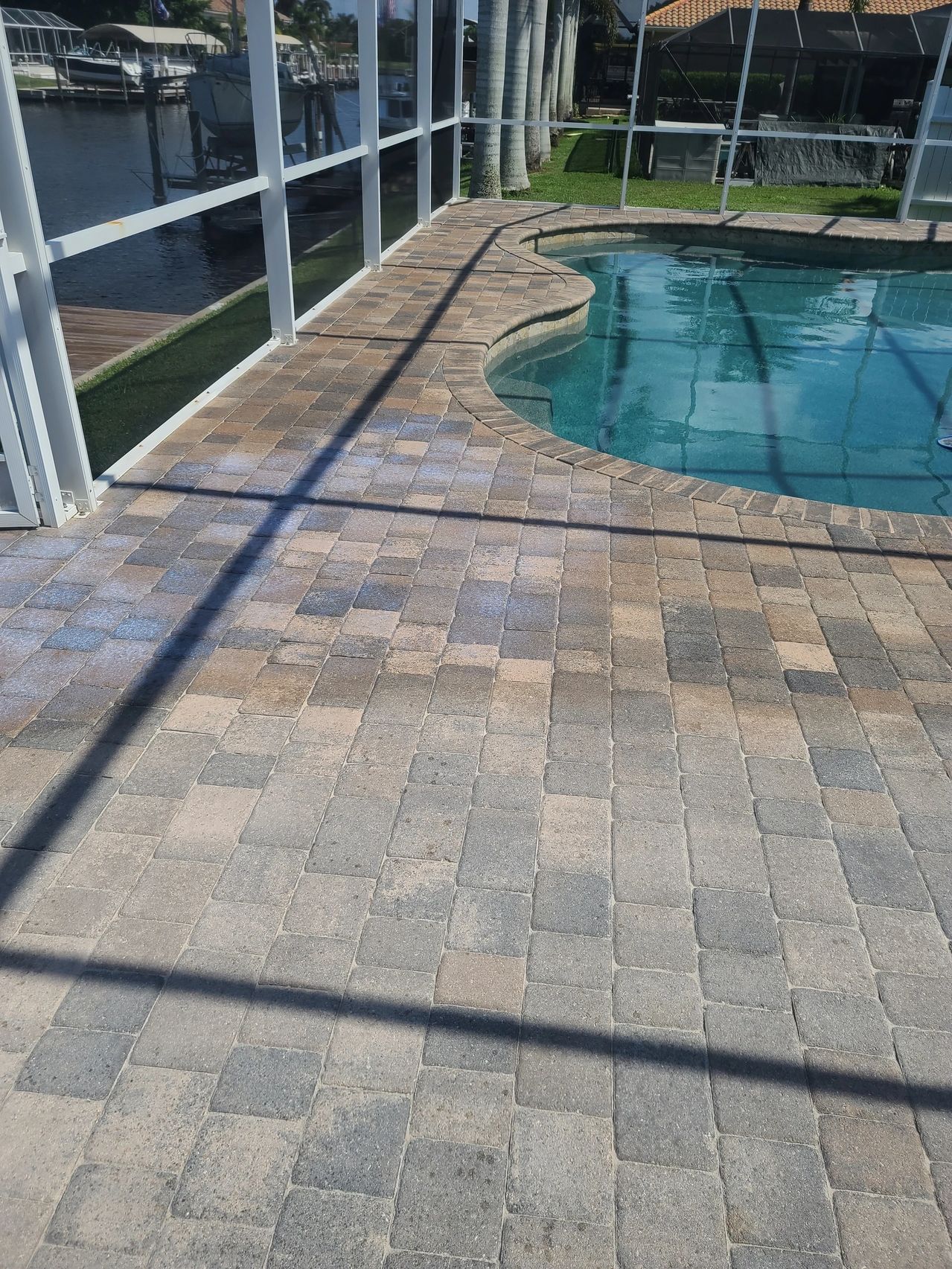 Screened pool deck with canal view