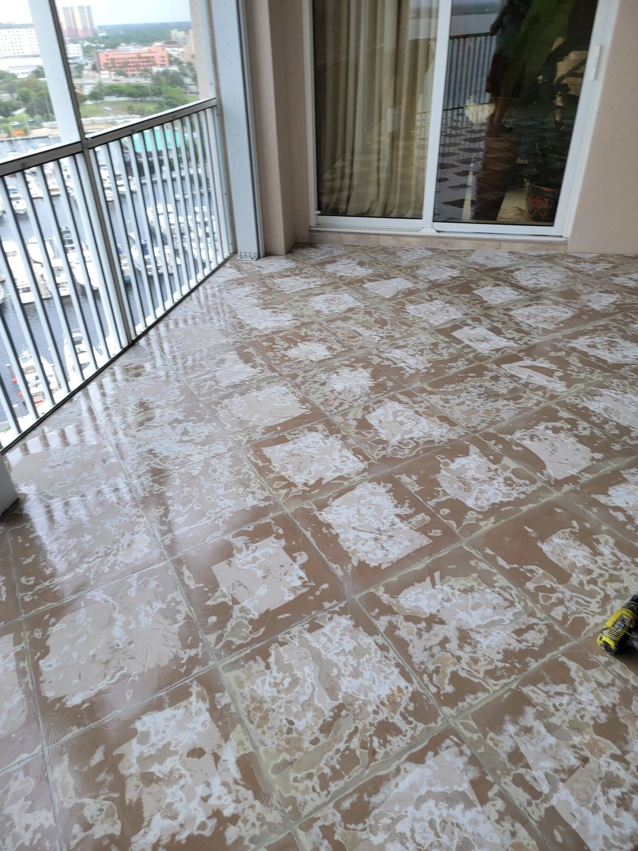 Tiled balcony floor with cleaning residue