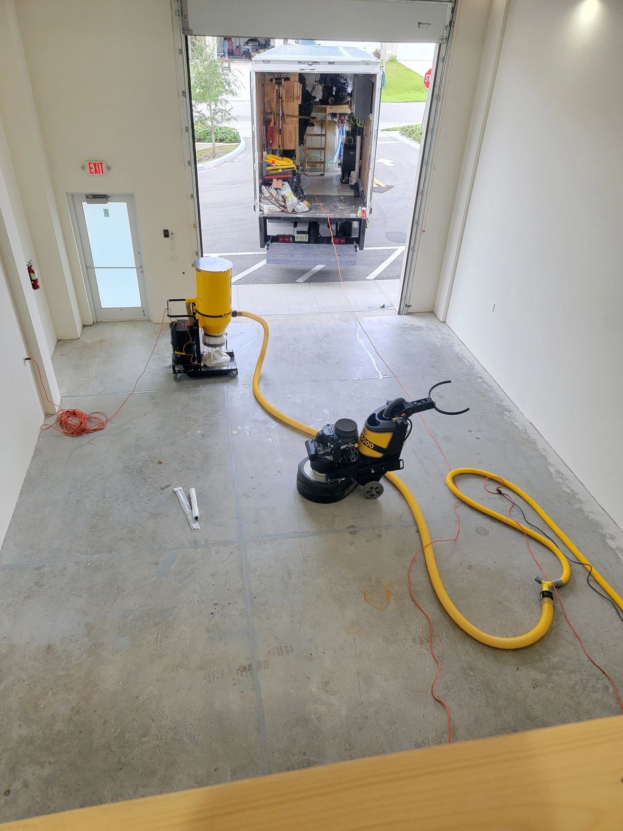 Empty warehouse with floor grinding machines
