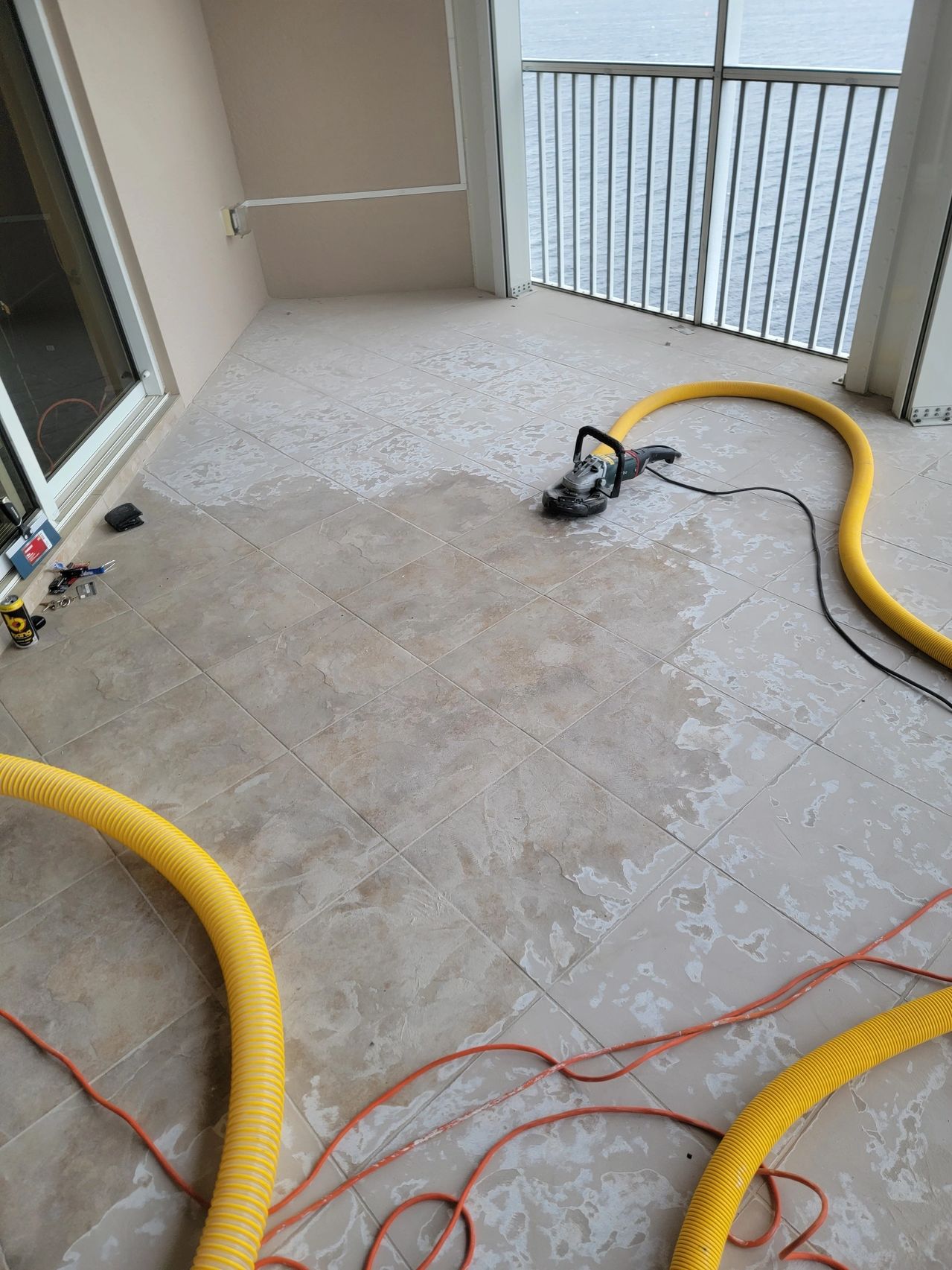 Wet tiled balcony with cleaning hoses