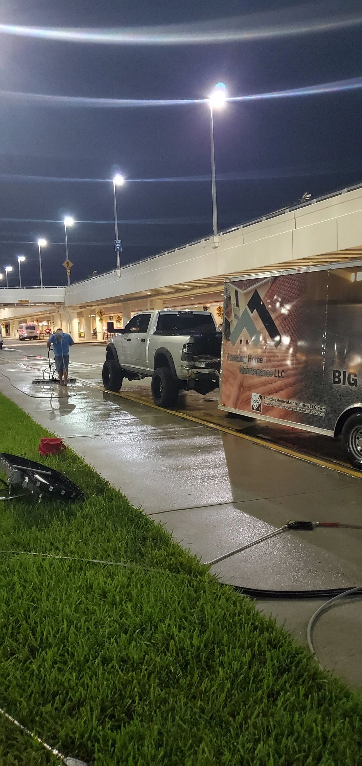 Truck and trailer parked under lit overpass