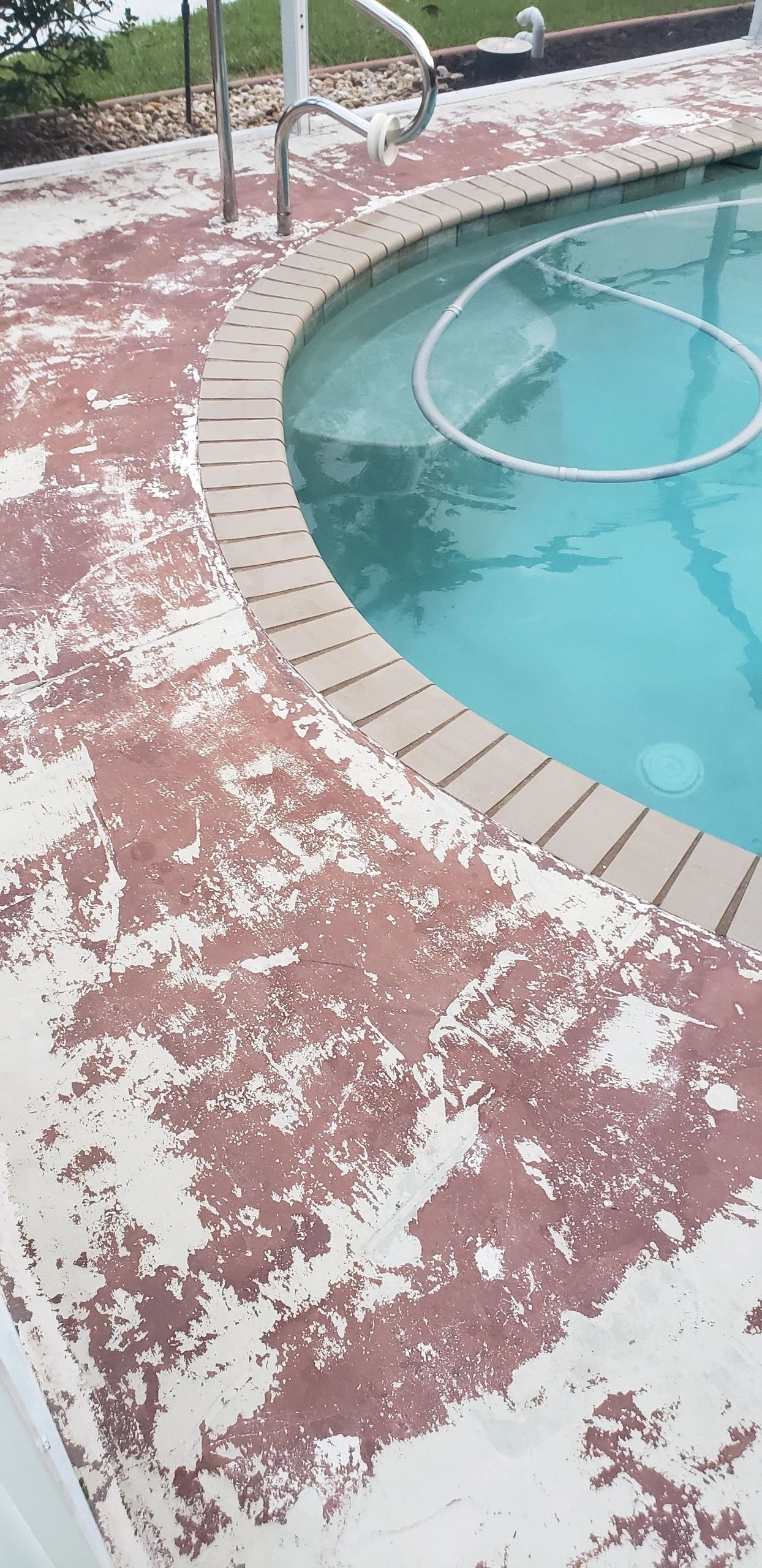 Peeling red paint on pool deck