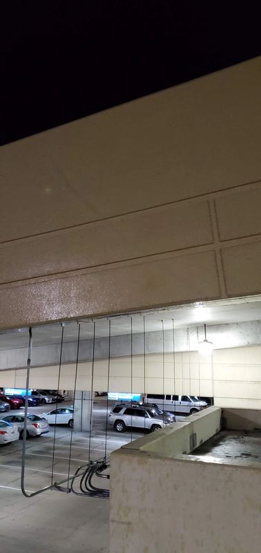 Dirty parking garage ceiling and support beams before commercial cleaning