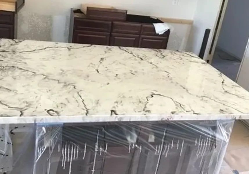 White marble kitchen island under installation