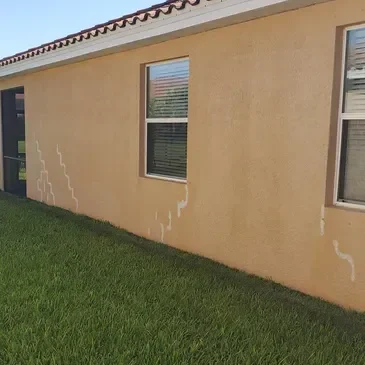 Stucco wall with white streaks and windows