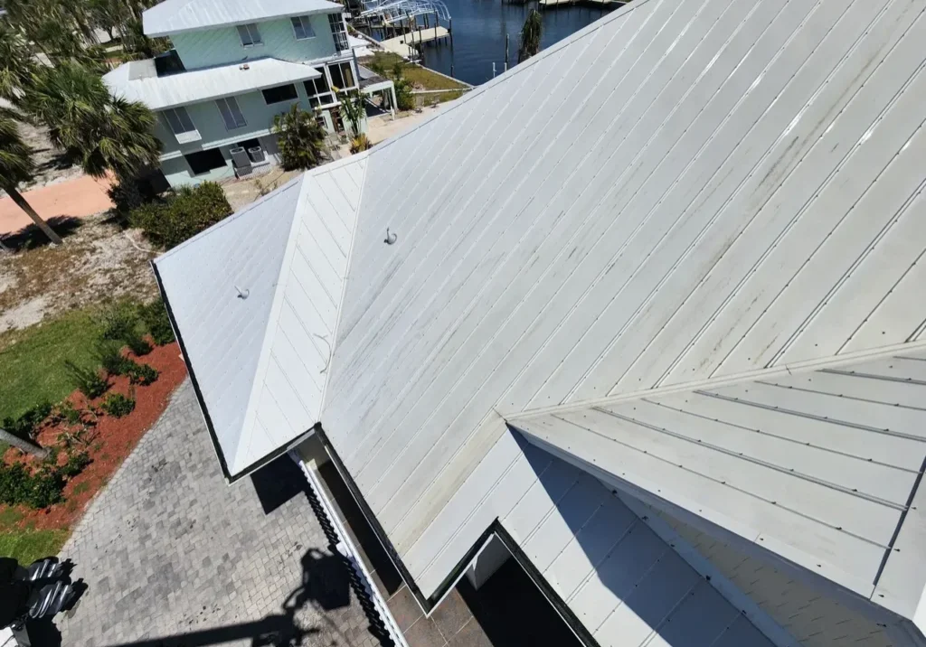Aerial view of white metal roofs near marina