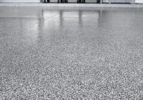 Polished speckled epoxy garage floor with cabinets