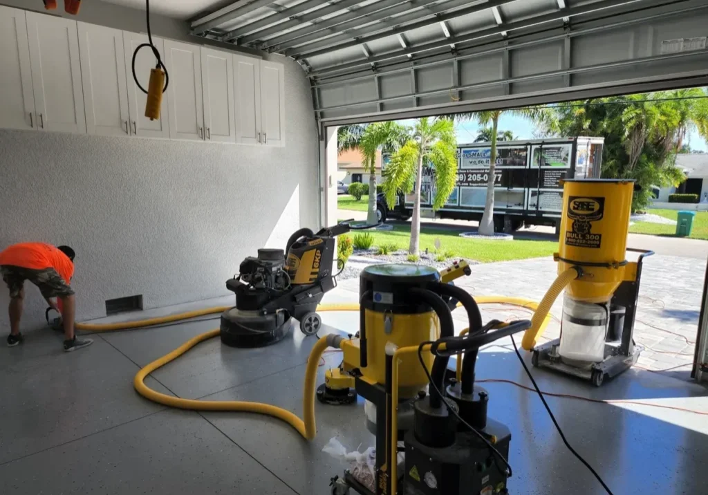 Garage floor resurfacing equipment and worker