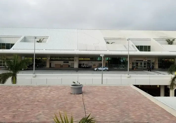 Airport terminal exterior with palm trees