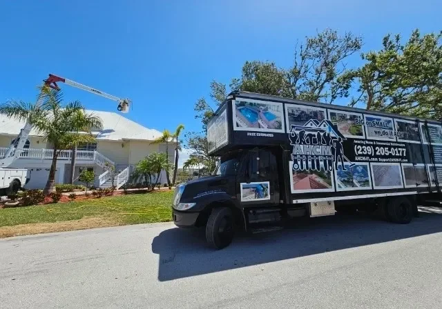 Moving truck parked by house with cherry picker