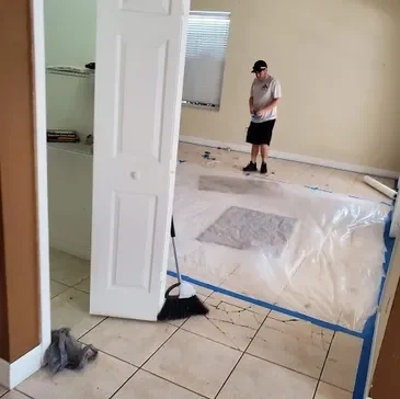 Worker preparing room for floor installation