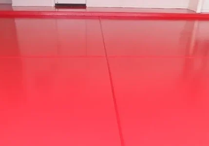 Shiny red epoxy floor with faint reflections