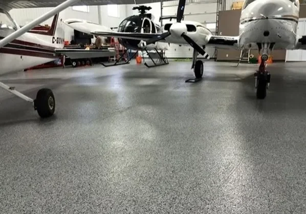 Small aircraft parked inside airplane hangar